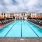 lap pool flanked by umbrella shaded lounge chairs