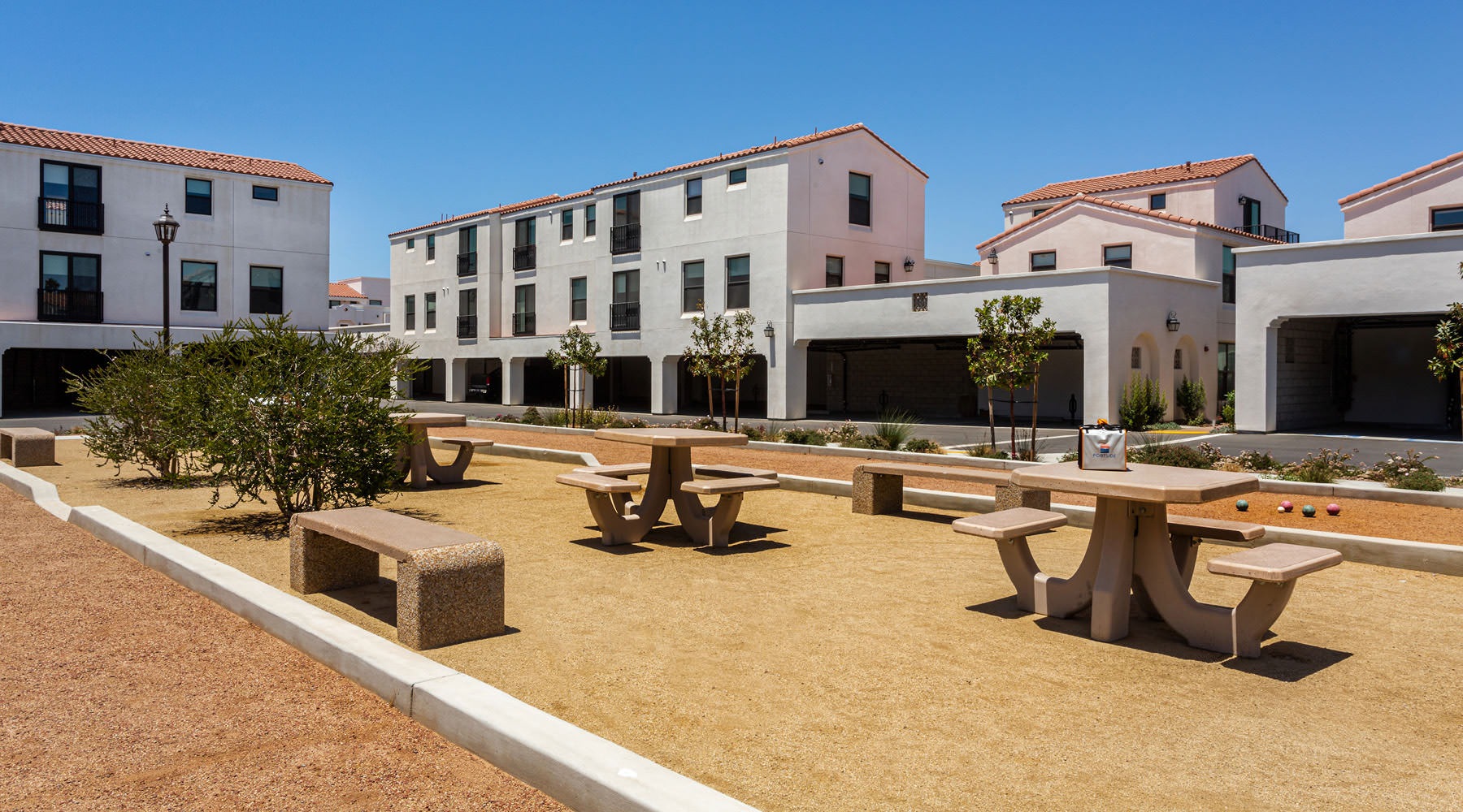 BEACHFRONT LUXURY a courtyard with tables and benches